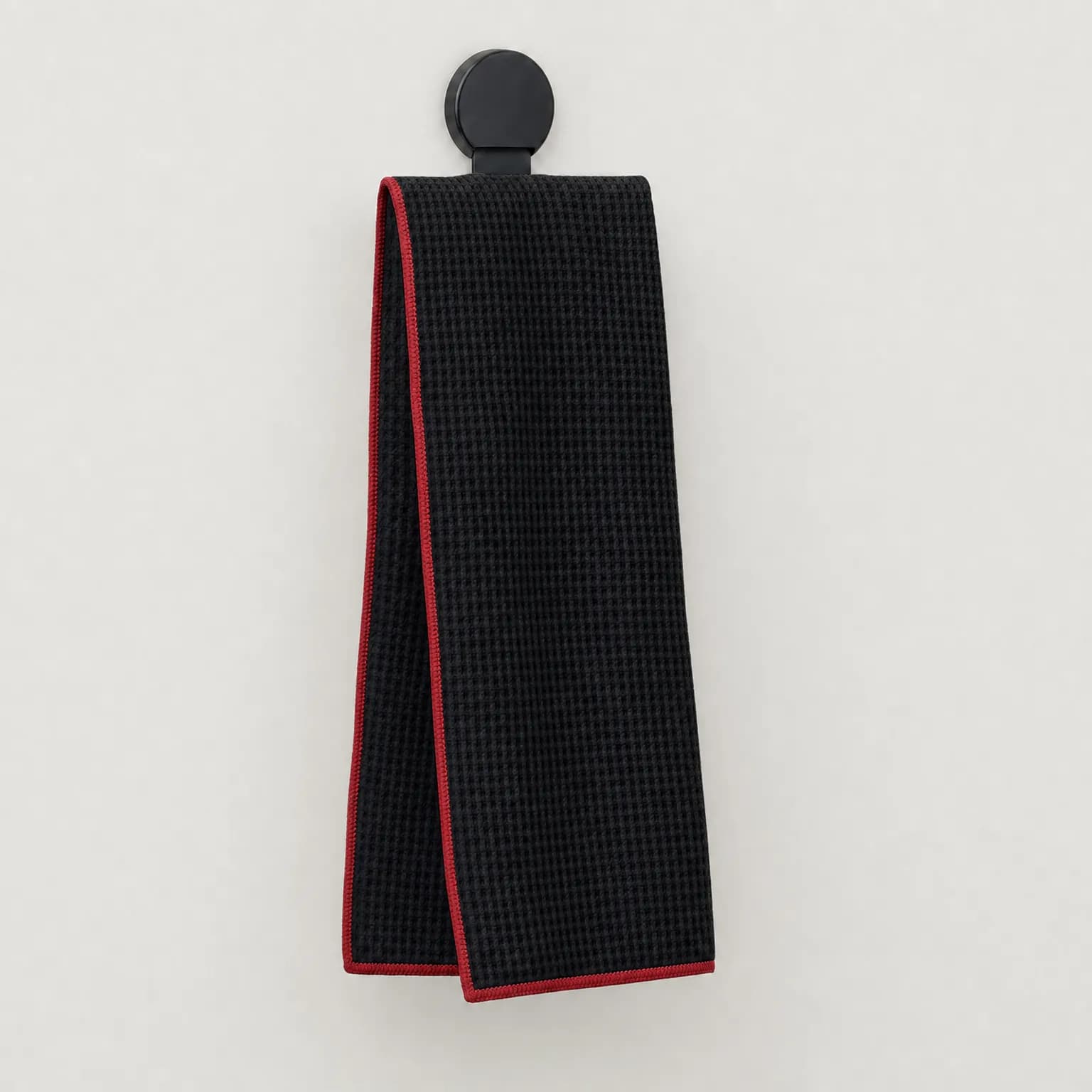 Black waffle-weave golf towel with magnetic clip