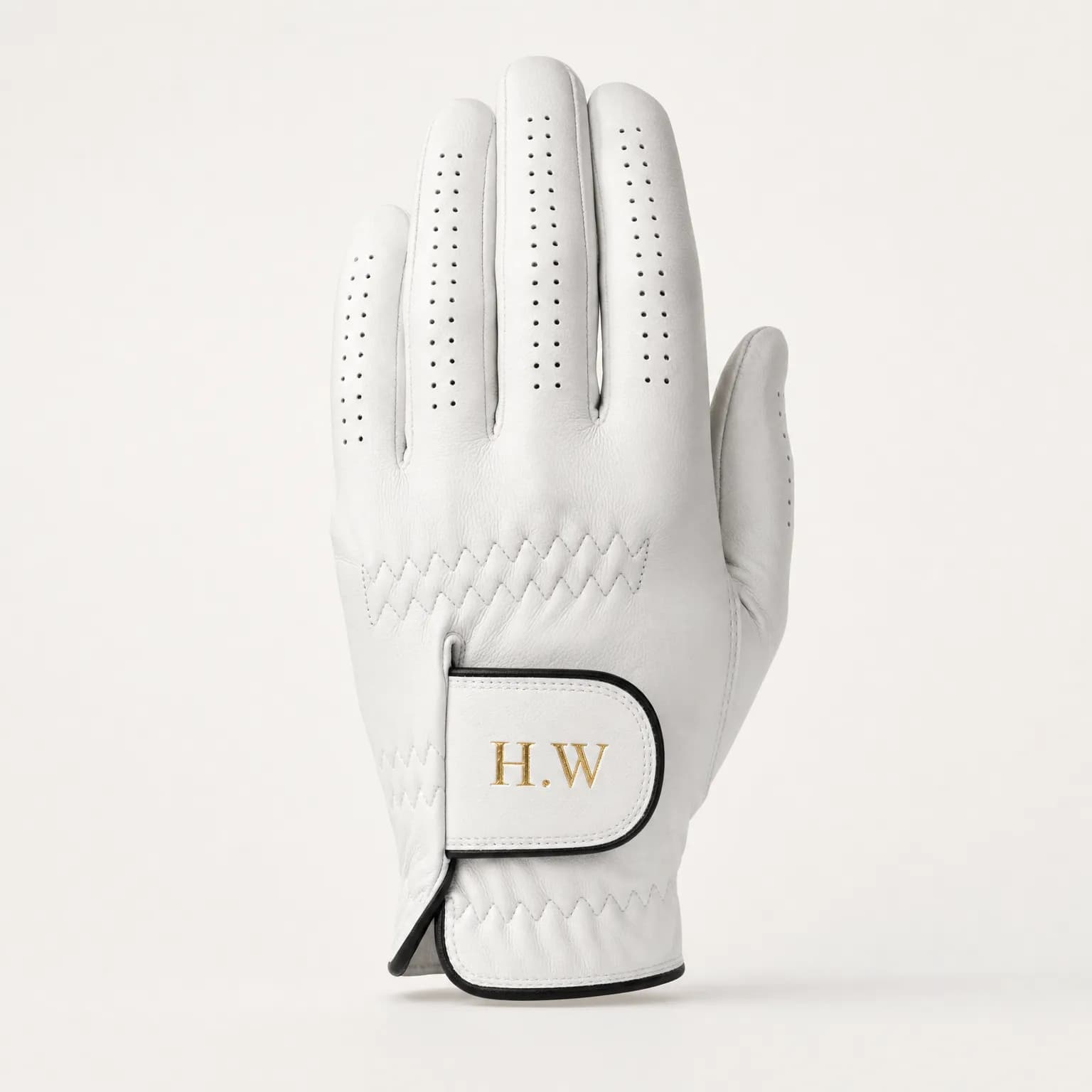 White Gilded Grip golf glove with initials hot-stamped in gold foil on the closure tab